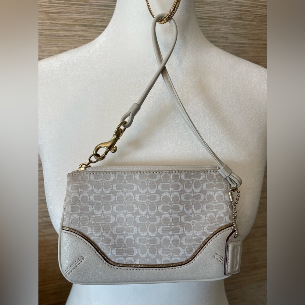 Coach wristlet with leather trim.
